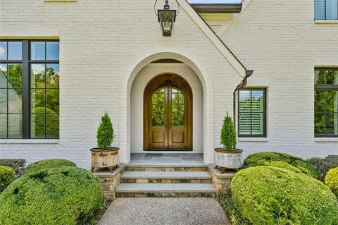 a front view of a house with garden