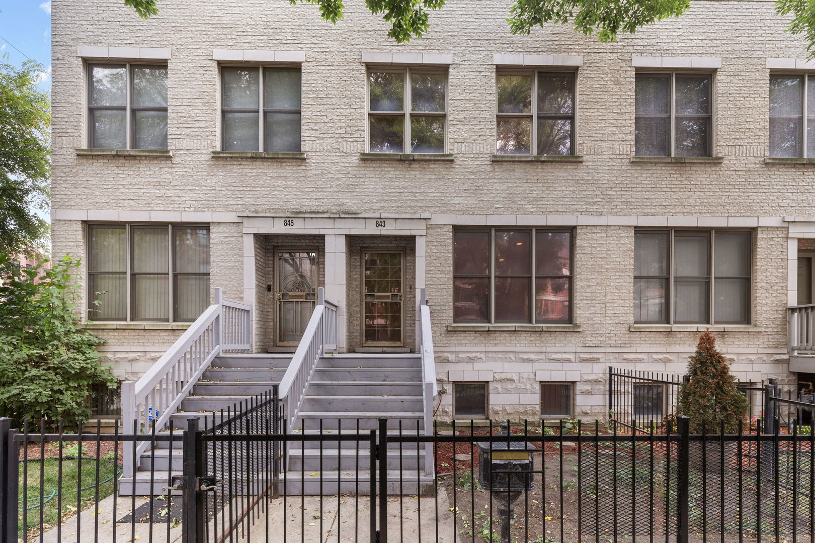 a view of a brick house with large windows