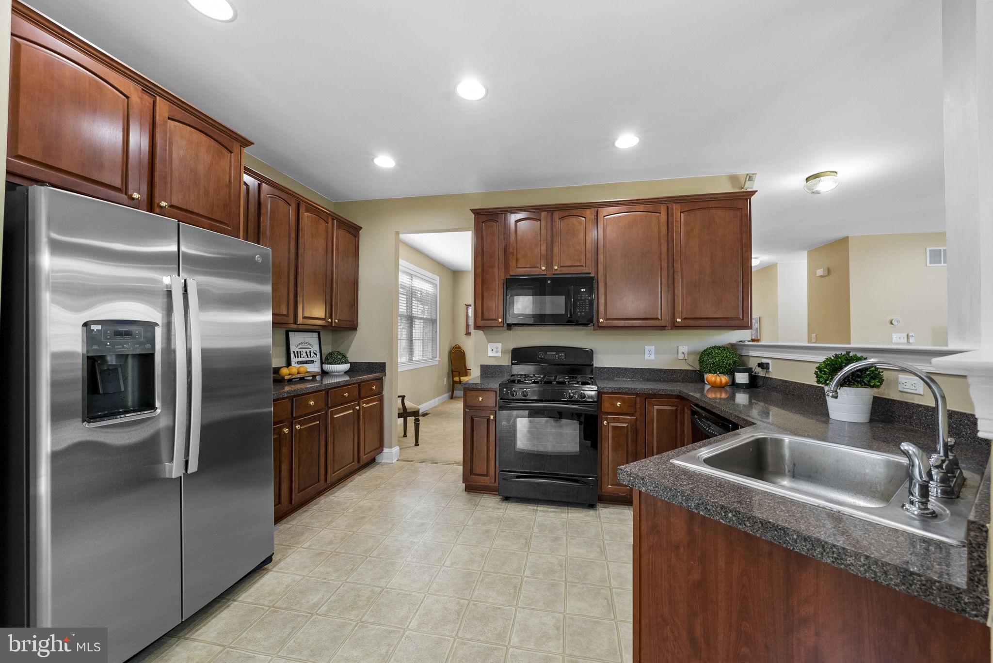 117 George Street Robbinsville, NJ 08691 - Photo 12 of 55 a kitchen with kitchen island granite countertop a refrigerator sink and stove