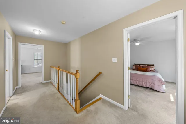 a spacious bedroom with a bed and a chandelier
