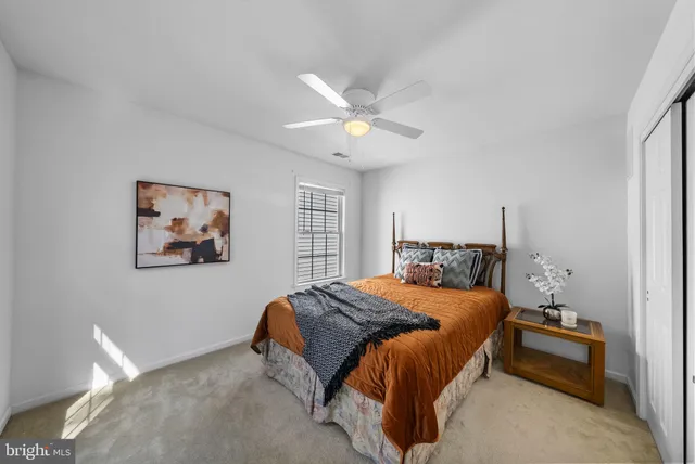 a bedroom with a bed and a lamp