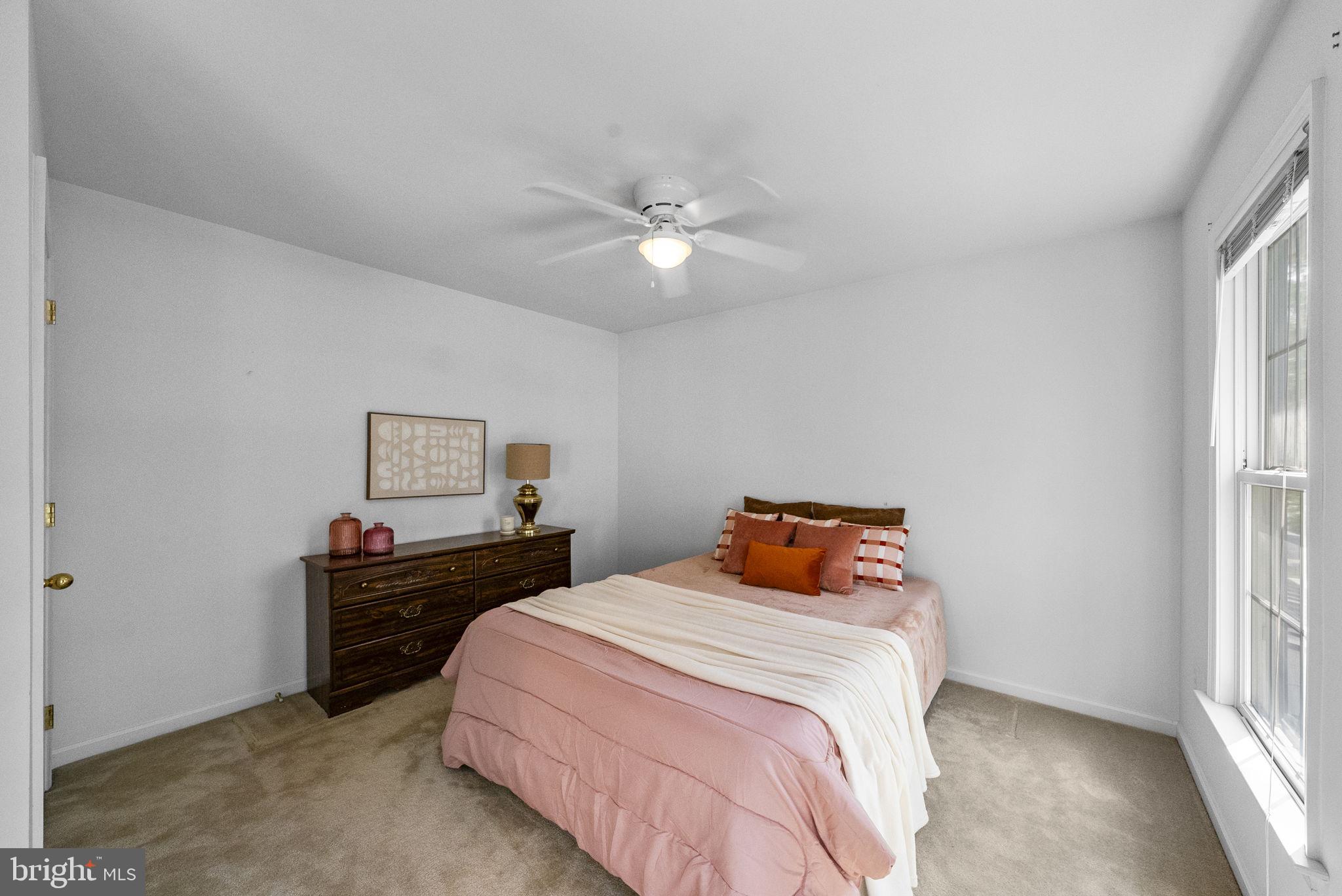117 George Street Robbinsville, NJ 08691 - Photo 40 of 55 a bedroom with a bed and a chandelier