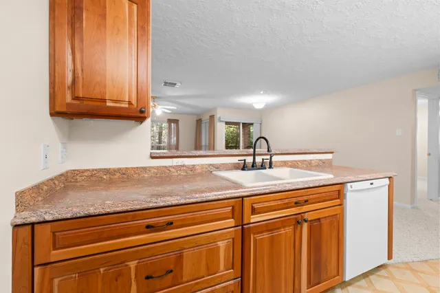 a kitchen with stainless steel appliances granite countertop a sink and cabinets
