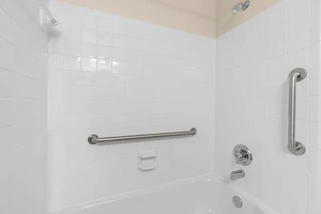 a bathroom with a shower and a bath tub