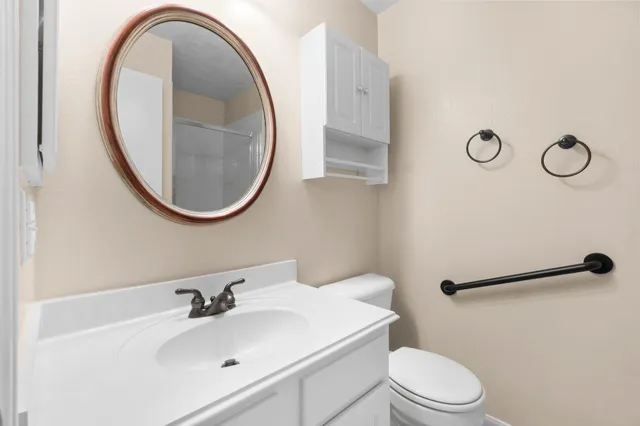 a bathroom with a sink a mirror and a toilet