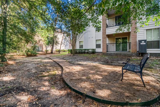a view of a backyard with table and chairs