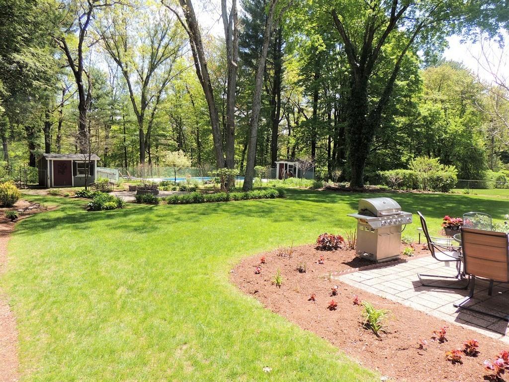 1321 Plumtree Road Springfield, MA 01119 - Photo 12 of 36 a front view of a house with garden and trees