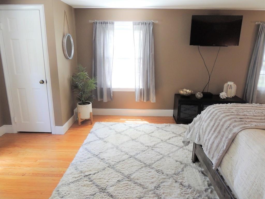1321 Plumtree Road Springfield, MA 01119 - Photo 27 of 36 a bedroom with a bed a flat screen tv and a large window
