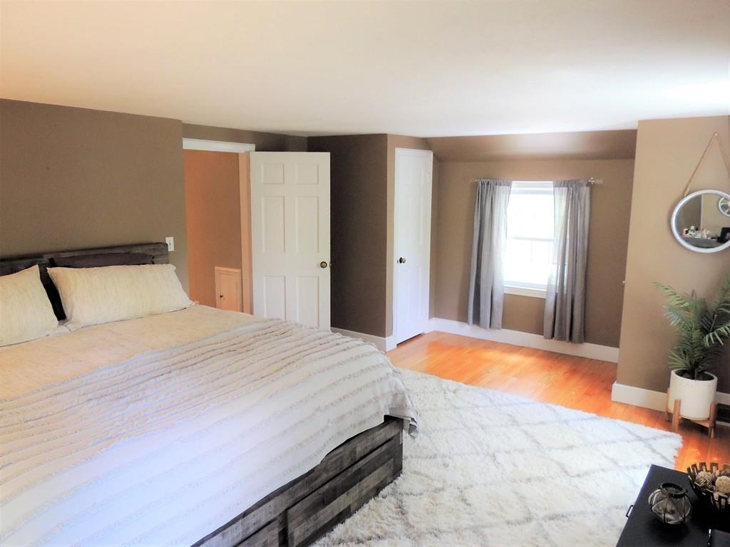 1321 Plumtree Road Springfield, MA 01119 - Photo 29 of 36 a bedroom with a bed and a potted plant