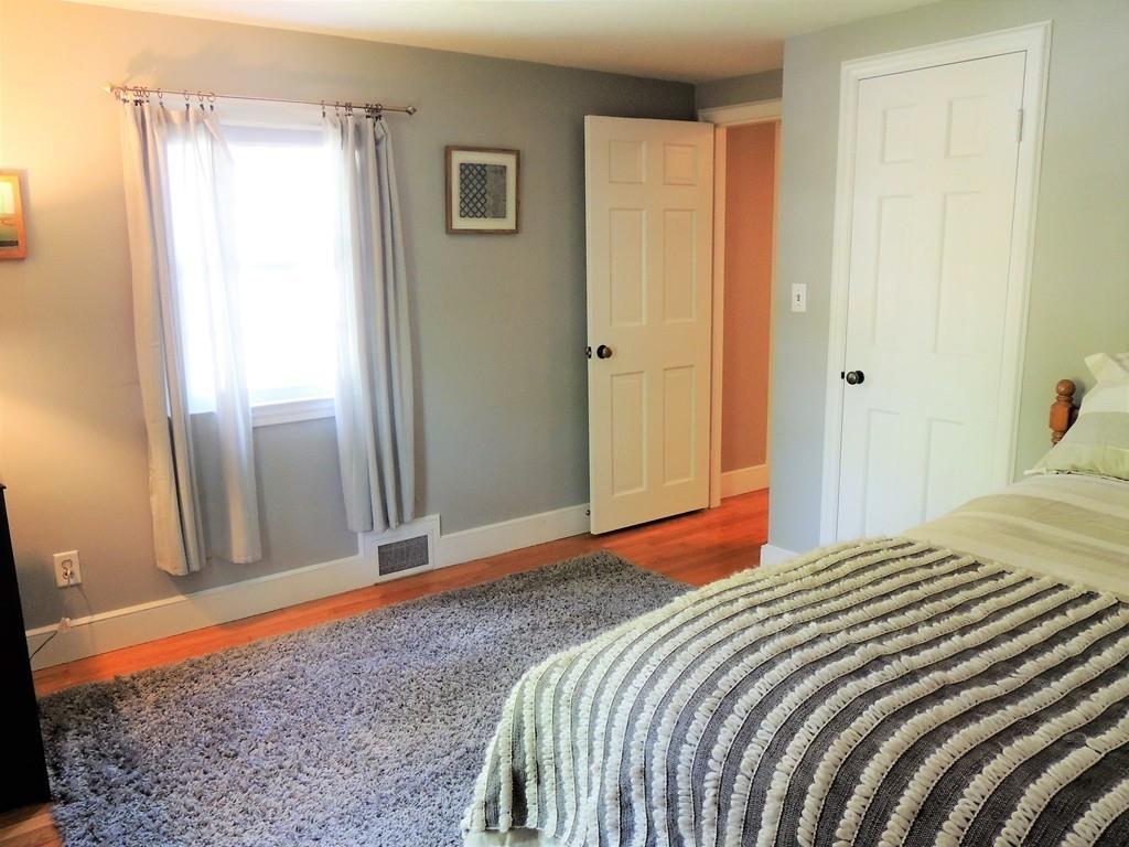 1321 Plumtree Road Springfield, MA 01119 - Photo 32 of 36 a bedroom with a bed and wooden floor