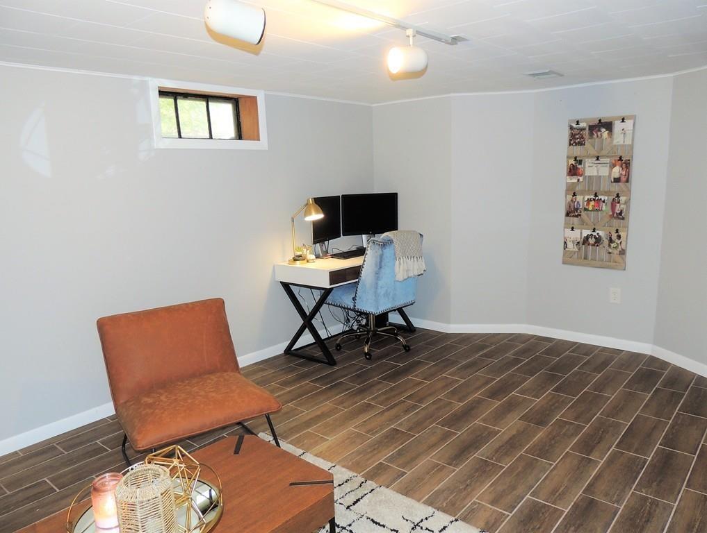 1321 Plumtree Road Springfield, MA 01119 - Photo 36 of 36 a workspace with wooden floor and a bookshelf
