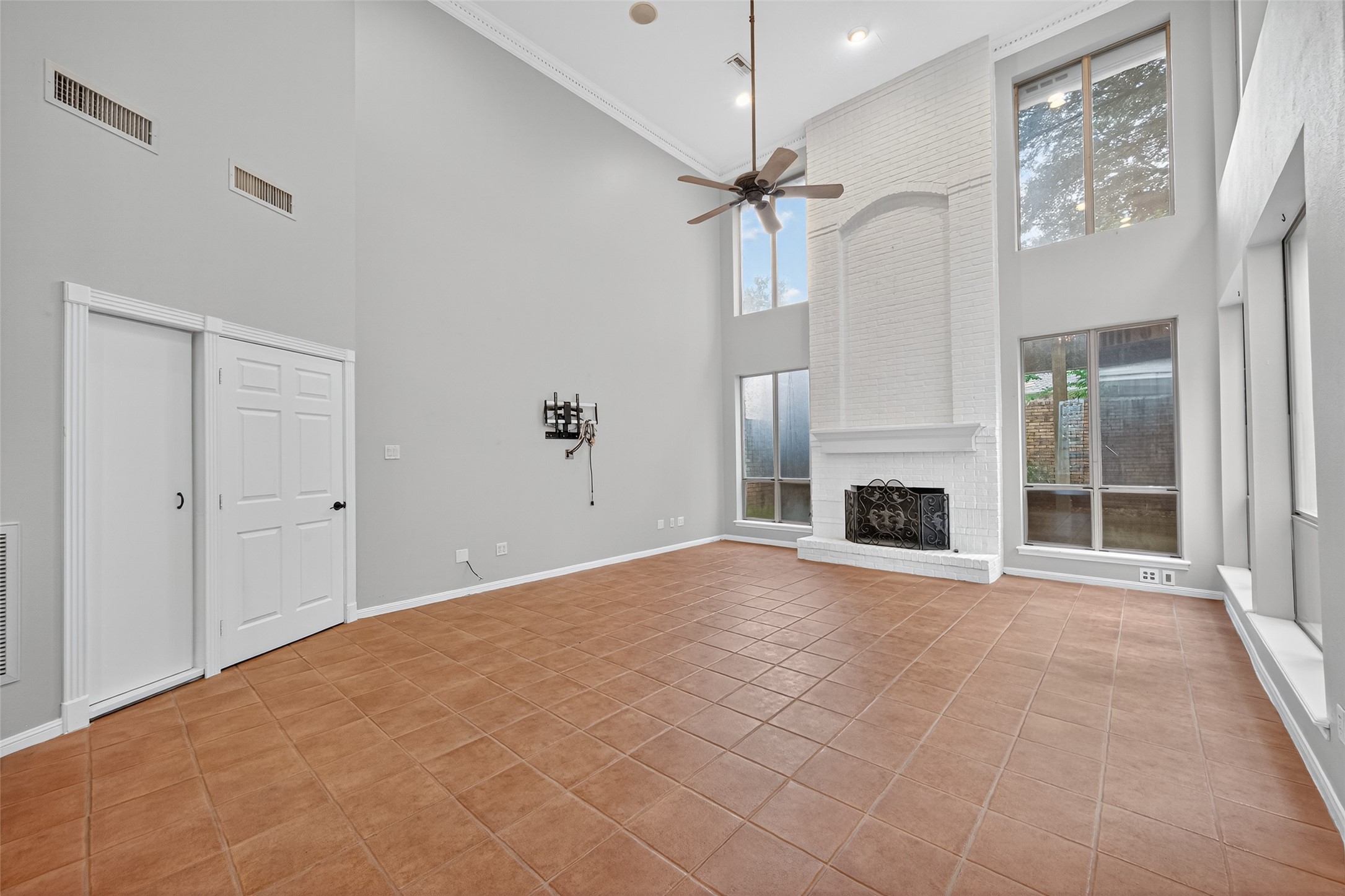 901 Longmire Road, Unit 13 Conroe, TX 77304 - Photo 14 of 46 a view of an empty room with a fireplace and a chandelier fan