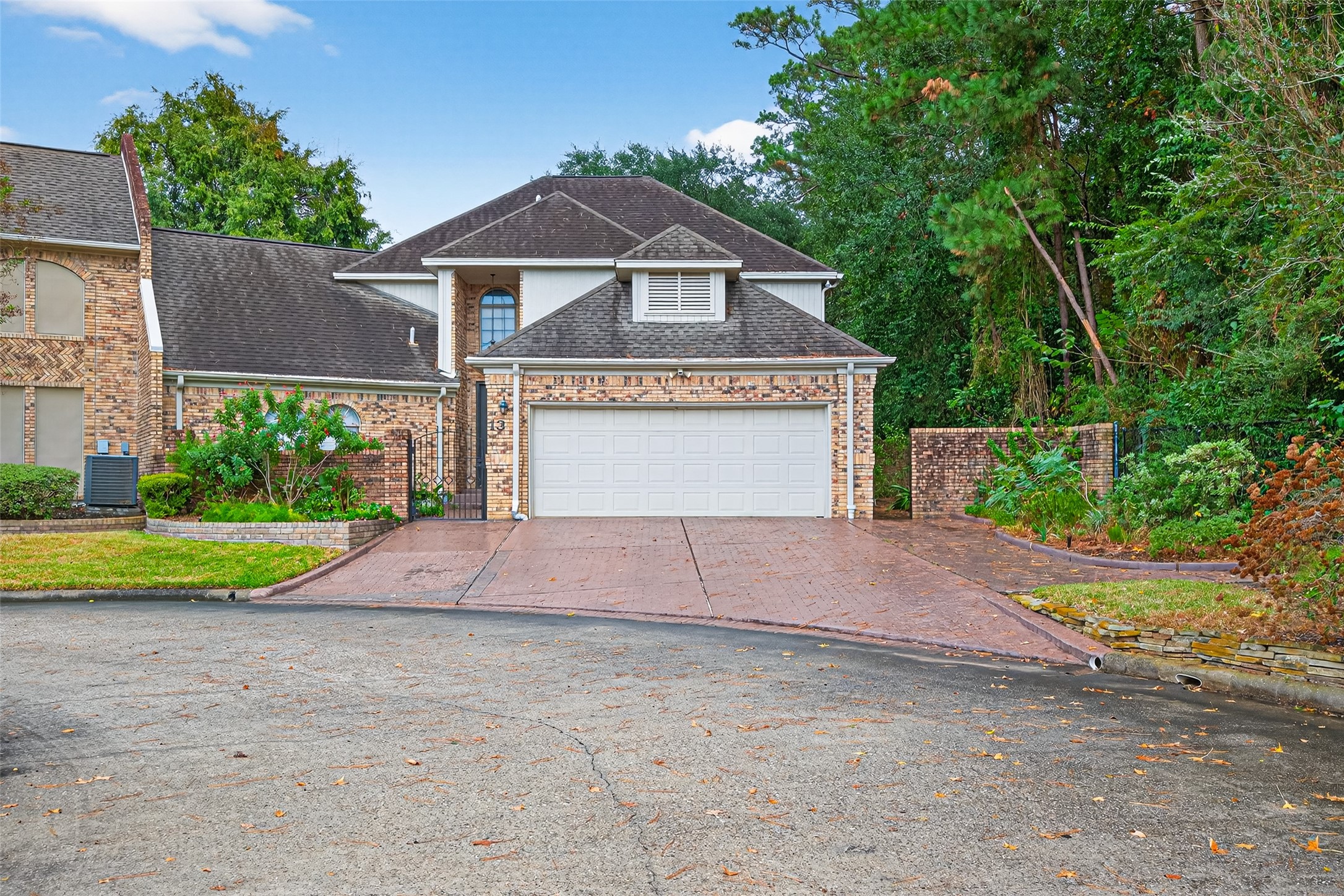 901 Longmire Road, Unit 13 Conroe, TX 77304 - Photo 2 of 46 a front view of a house with a yard and garage