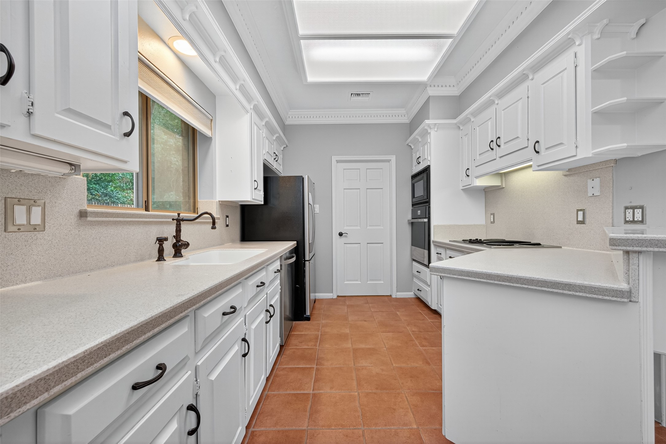 901 Longmire Road, Unit 13 Conroe, TX 77304 - Photo 21 of 46 a kitchen with cabinets and sink