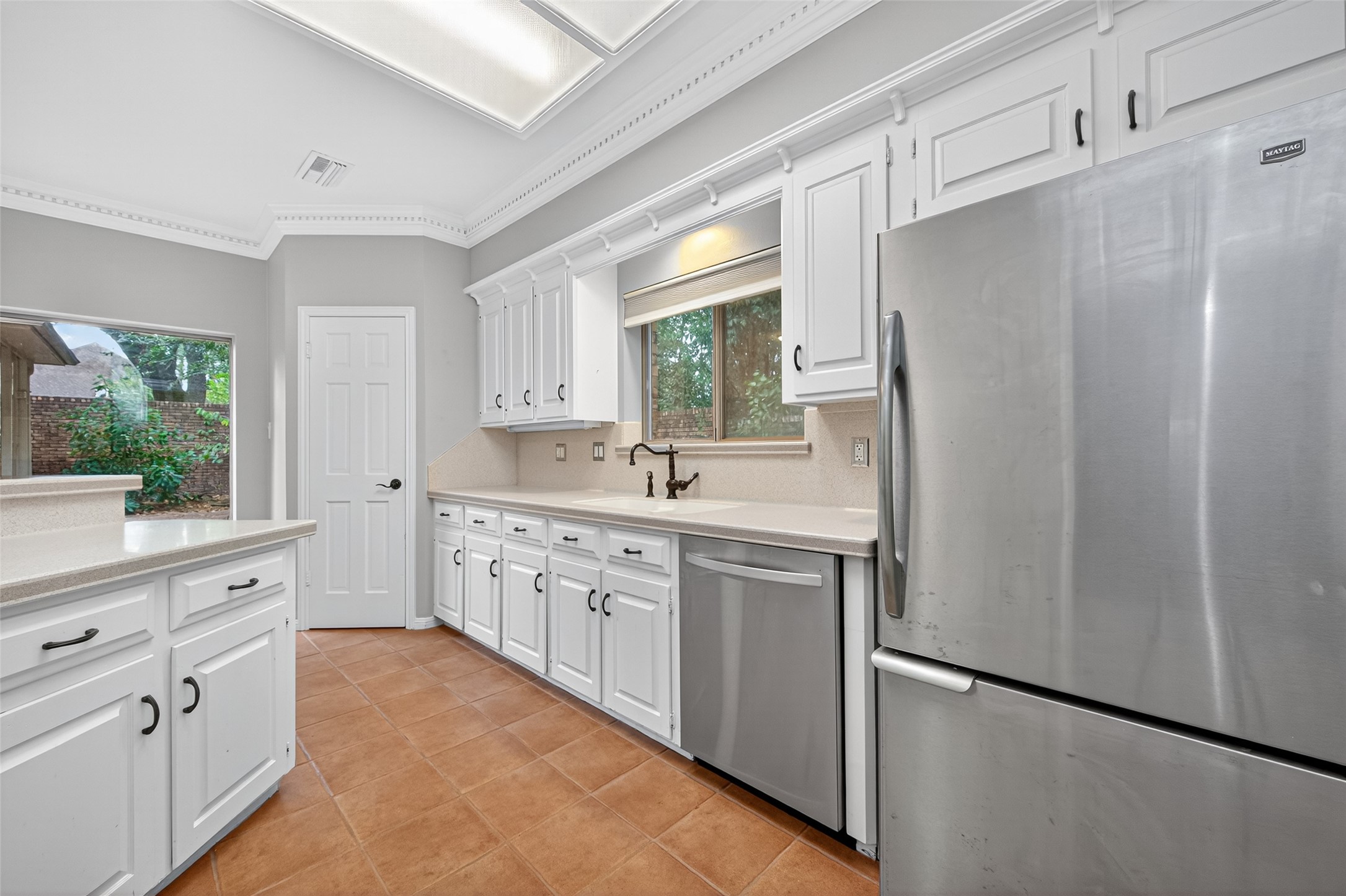 901 Longmire Road, Unit 13 Conroe, TX 77304 - Photo 25 of 46 a kitchen with white cabinets and white appliances