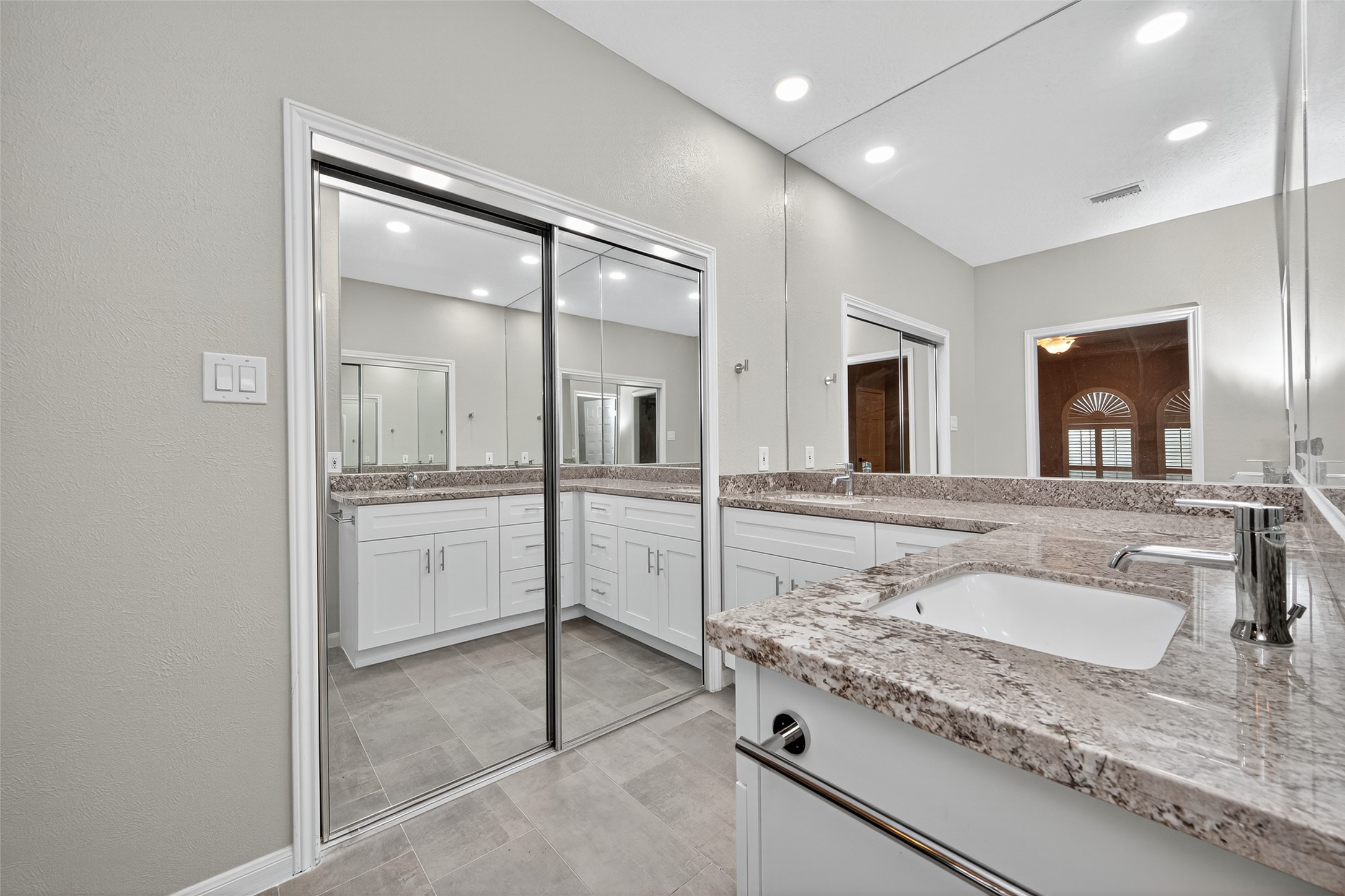 901 Longmire Road, Unit 13 Conroe, TX 77304 - Photo 33 of 46 a bathroom with a granite countertop sink mirror and