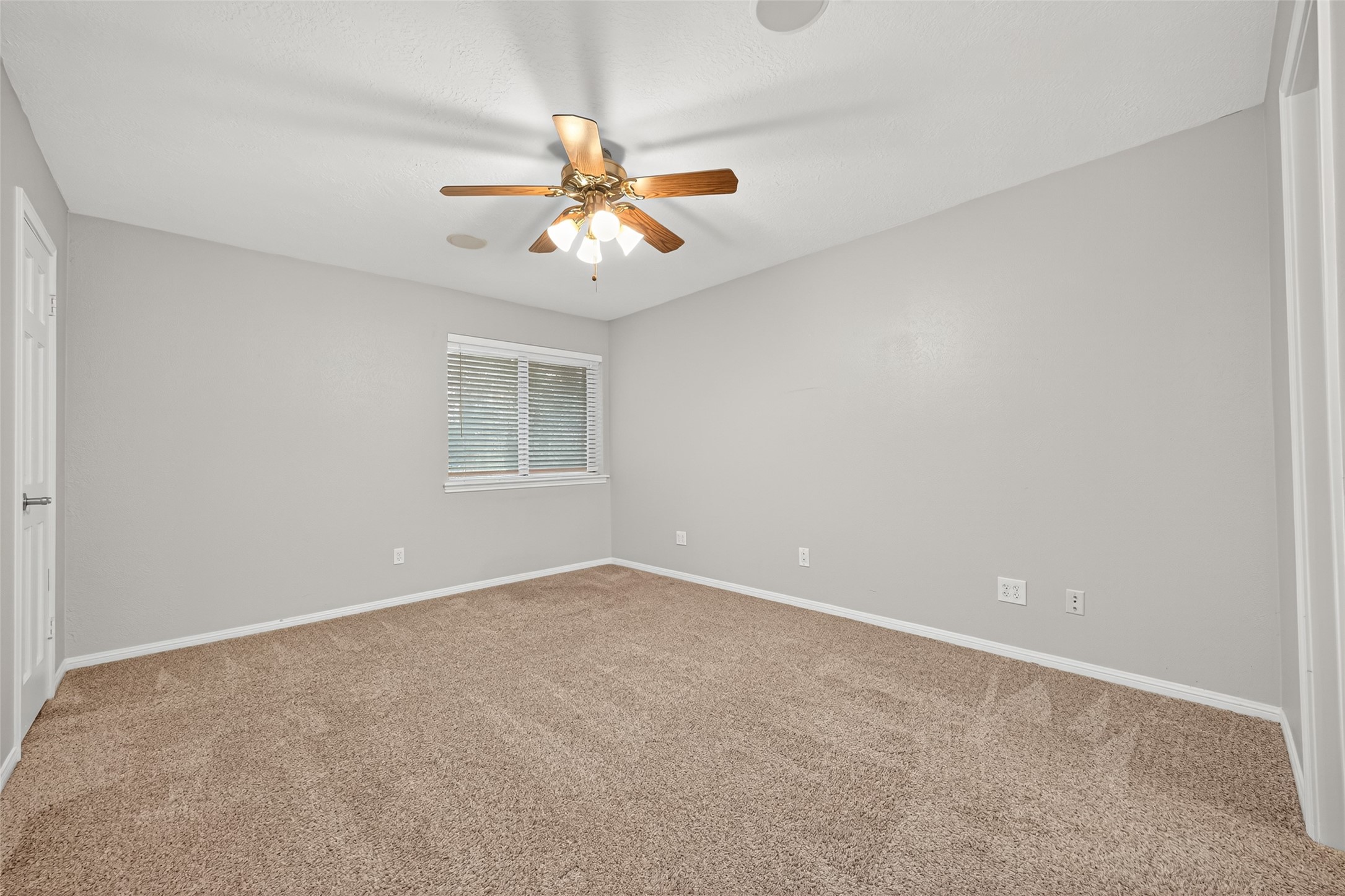 901 Longmire Road, Unit 13 Conroe, TX 77304 - Photo 37 of 46 an empty room with a window and a fan