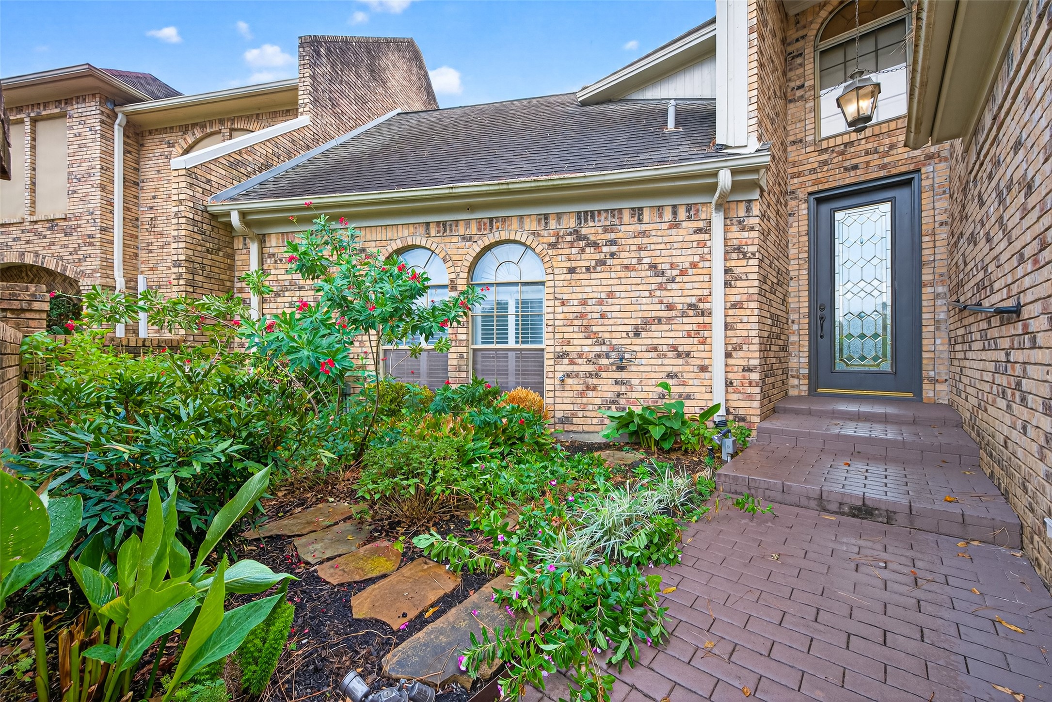 901 Longmire Road, Unit 13 Conroe, TX 77304 - Photo 4 of 46 a front view of a house with garden