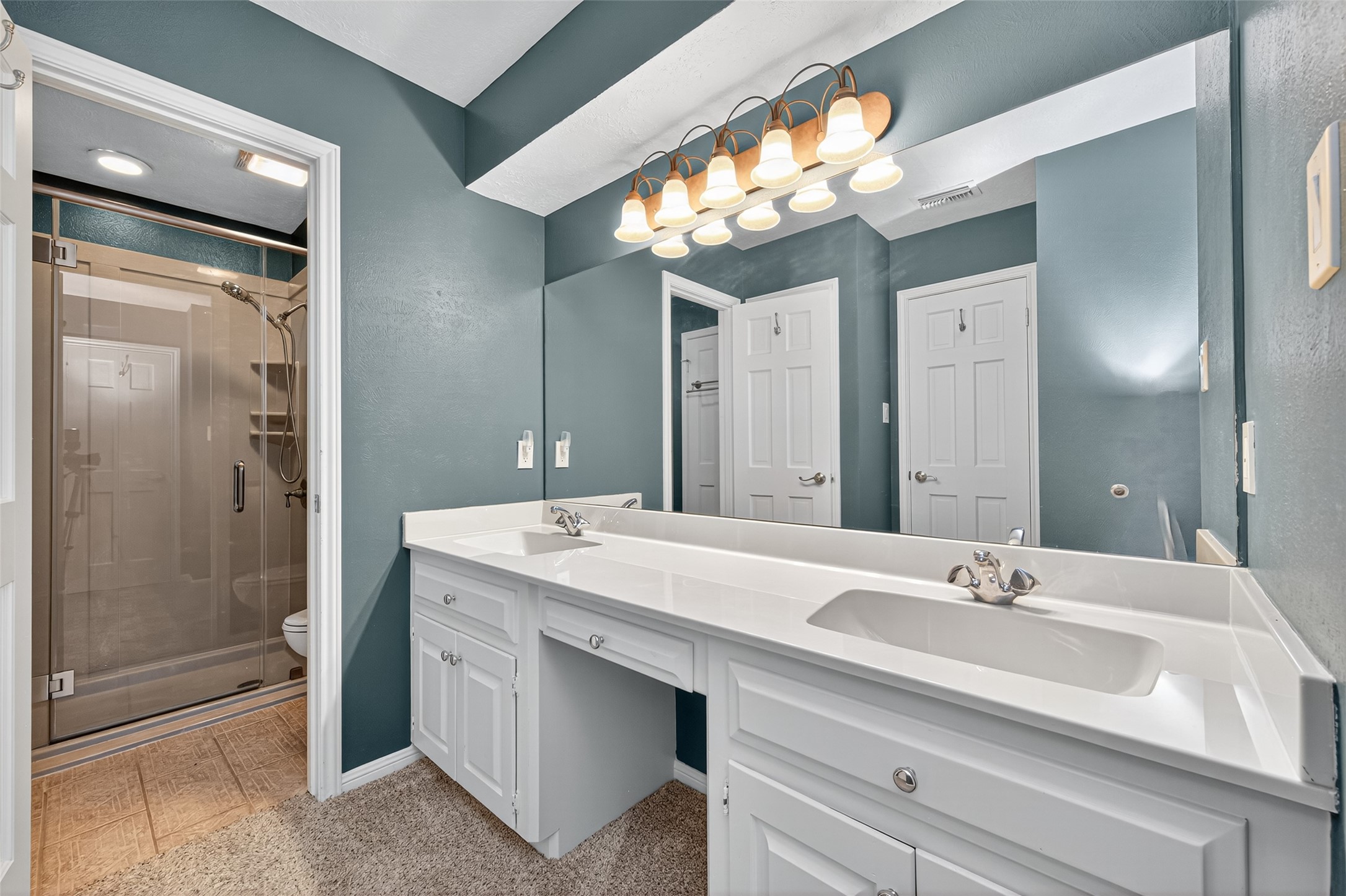 901 Longmire Road, Unit 13 Conroe, TX 77304 - Photo 41 of 46 a bathroom with a sink double vanity and a mirror