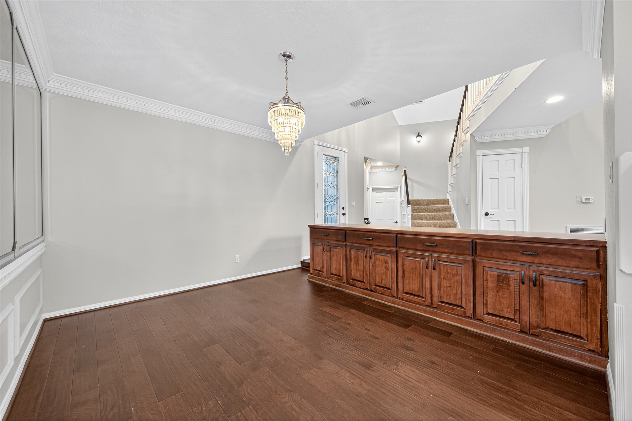 901 Longmire Road, Unit 13 Conroe, TX 77304 - Photo 9 of 46 The dining area is accentuated by a long wooden cabinet with ample storage, and a decorative mirrored wall that adds a touch of sophistication.