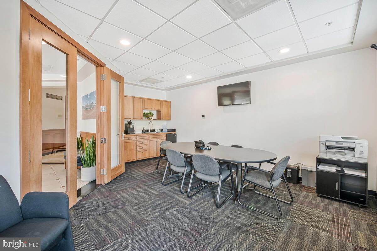 23 Pierside Drive, Unit 129 Baltimore, MD 21230 - Photo 13 of 19 a view of a dining room with furniture window and wooden floor