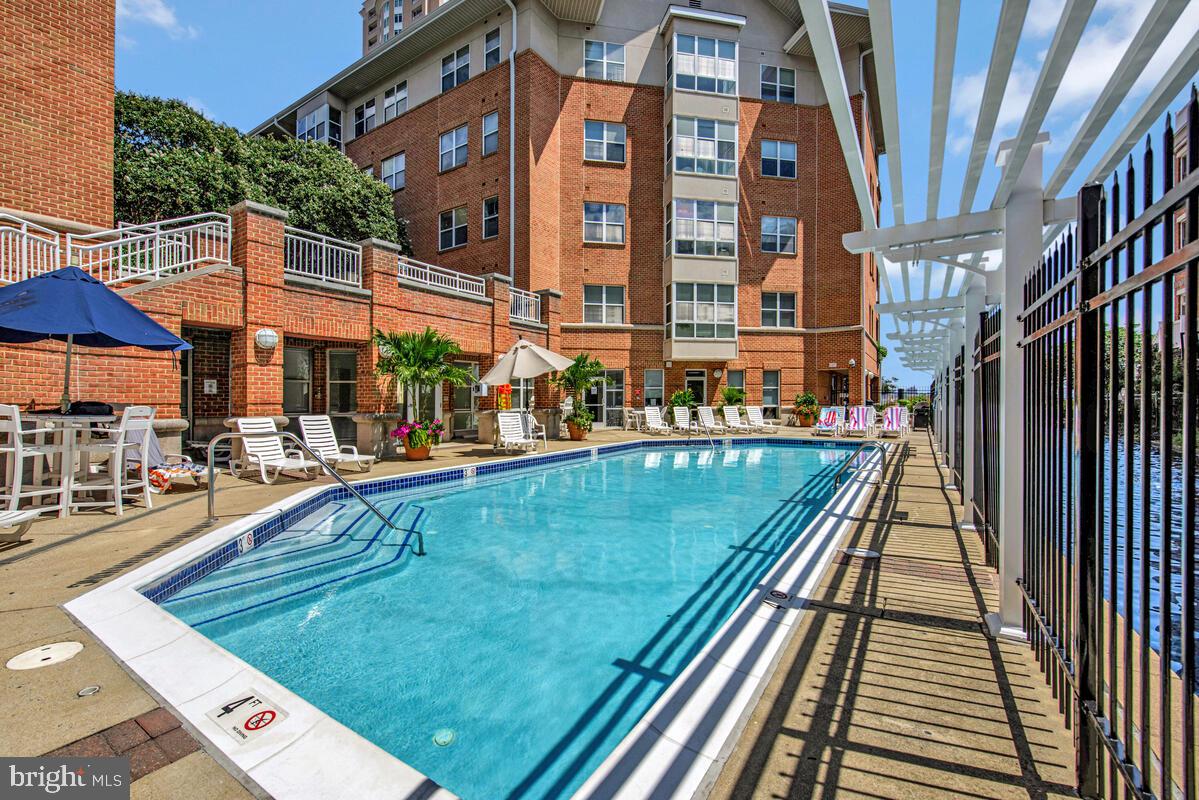 23 Pierside Drive, Unit 129 Baltimore, MD 21230 - Photo 15 of 19 a view of a swimming pool with a lounge chairs