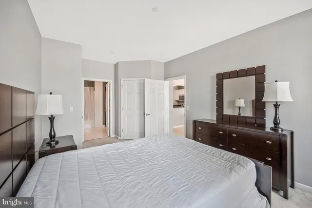 a bedroom with a bed and a dresser