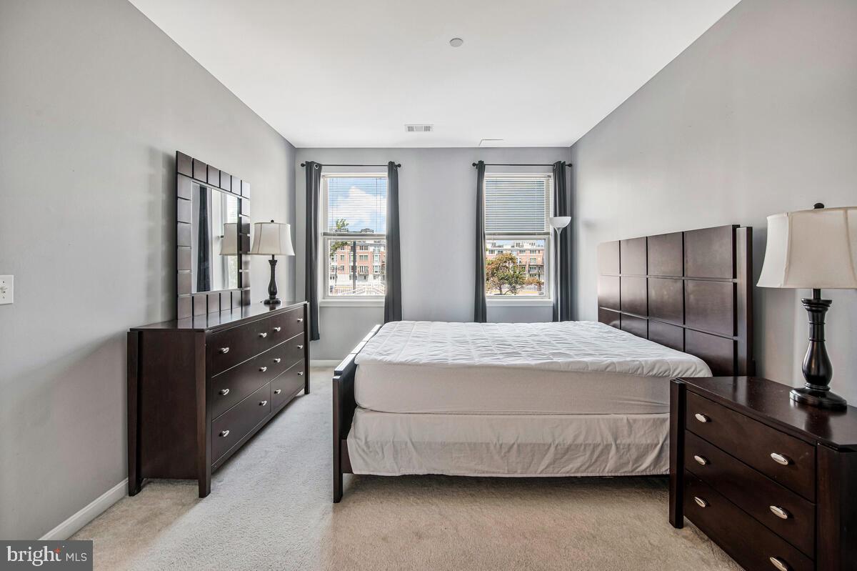 23 Pierside Drive, Unit 129 Baltimore, MD 21230 - Photo 9 of 19 a bedroom with a bed and window