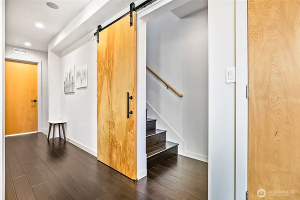 a view of an entryway with wooden floor and door