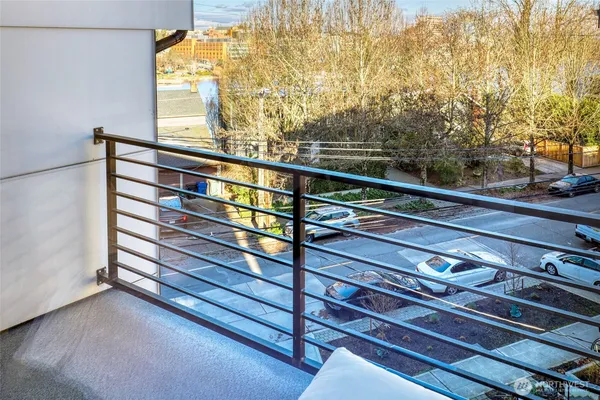 a view of a balcony with wooden floor and fence