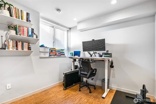 a view of a workspace with furniture and a bookshelf