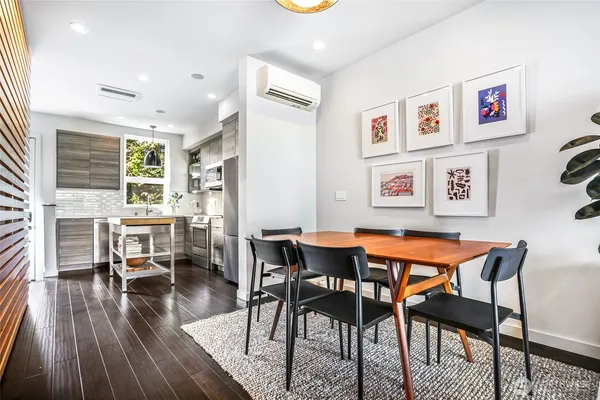 a dining room with furniture and wooden floor