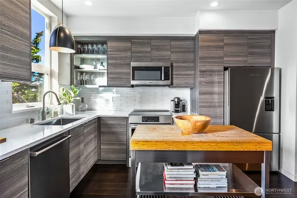 a kitchen with a sink appliances and cabinets