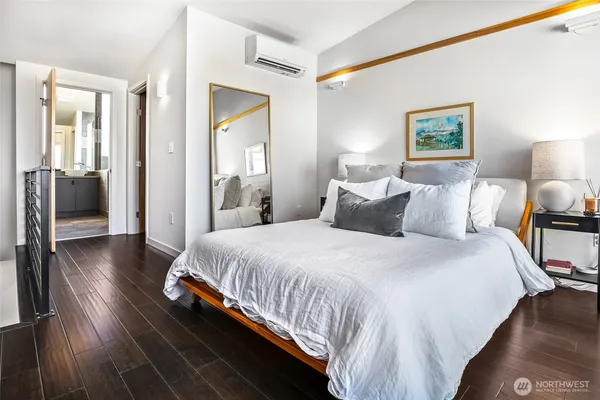 a bedroom with bed and wooden floor