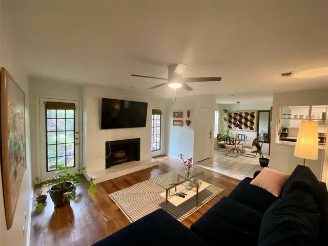 a living room with furniture a fireplace and a flat screen tv