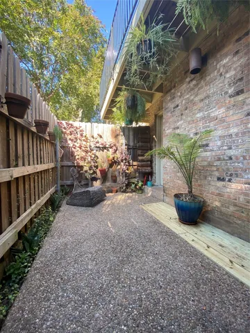 a view of a backyard with potted plants