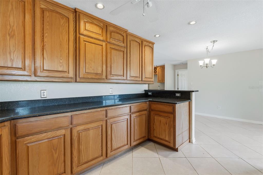 25391 Rupert Road Punta Gorda, FL 33983 - Photo 16 of 38 a kitchen with granite countertop a sink cabinets and stainless steel appliances