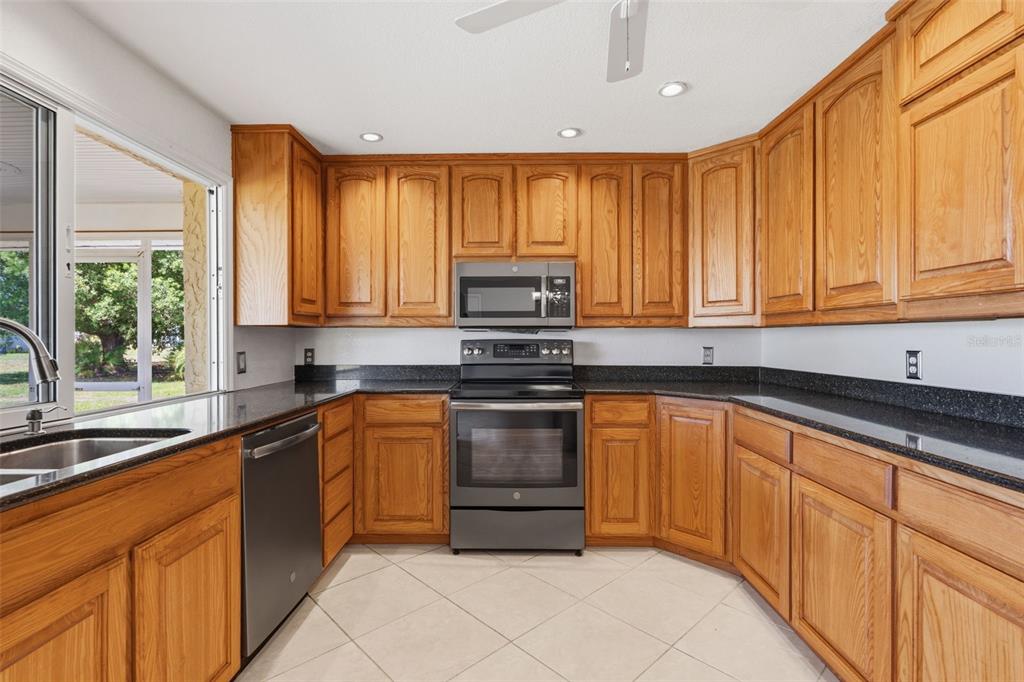 25391 Rupert Road Punta Gorda, FL 33983 - Photo 2 of 38 a kitchen with stainless steel appliances granite countertop a stove sink and cabinets