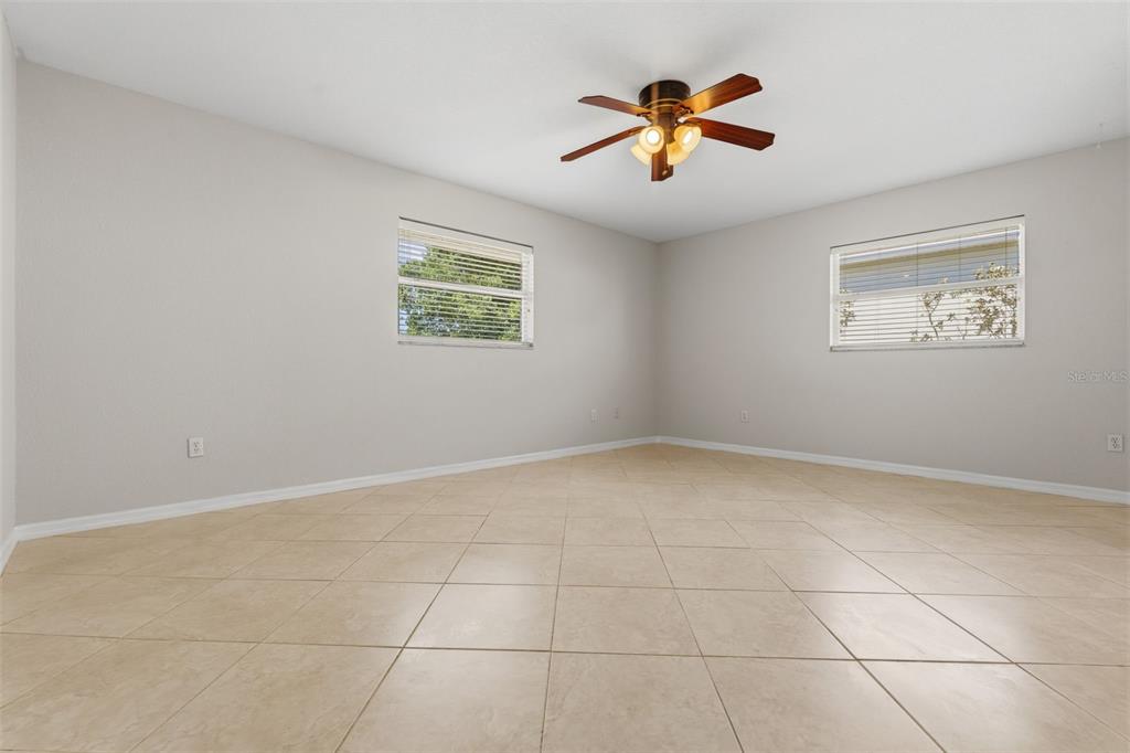 25391 Rupert Road Punta Gorda, FL 33983 - Photo 26 of 38 a view of an empty room with a ceiling fan
