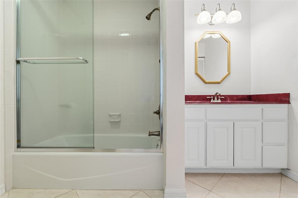 25391 Rupert Road Punta Gorda, FL 33983 - Photo 30 of 38 a bathroom with a sink a mirror and a bathtub