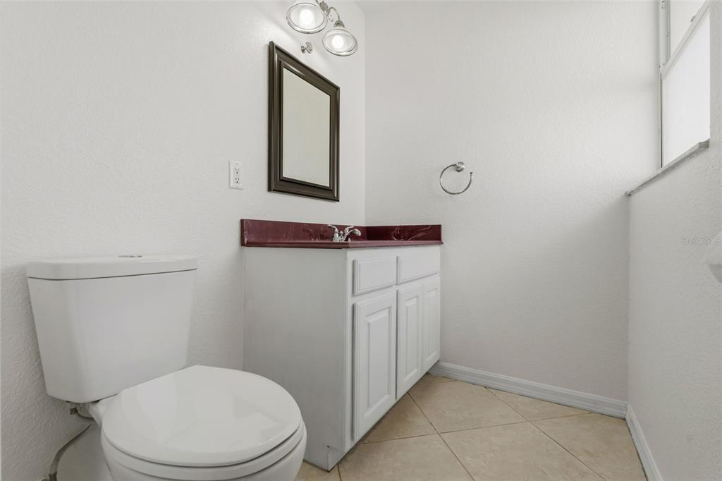 25391 Rupert Road Punta Gorda, FL 33983 - Photo 32 of 38 a bathroom with a toilet a sink and mirror