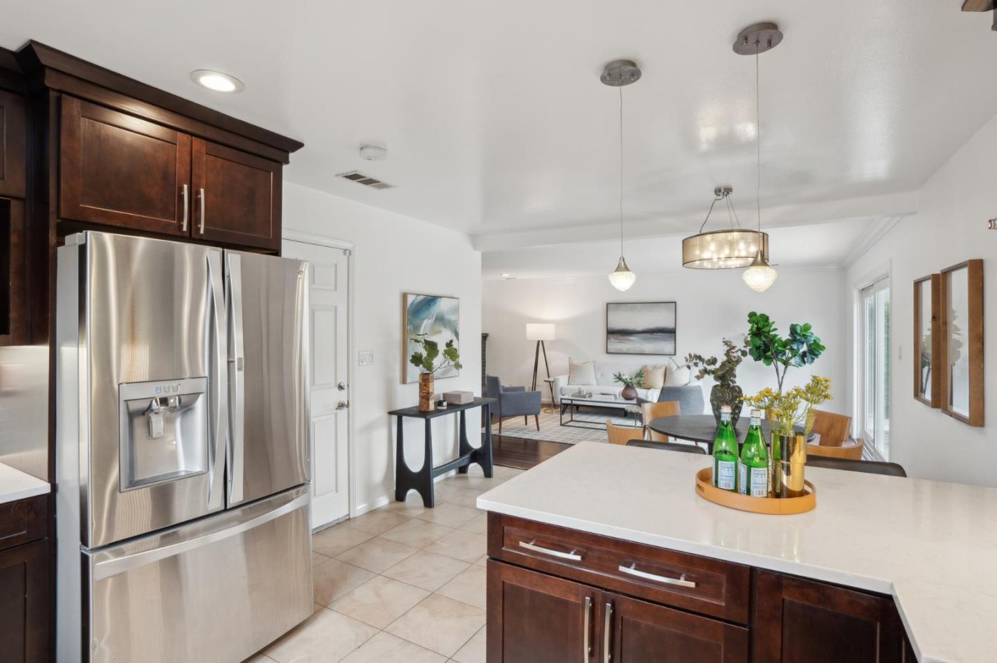907 3rd Avenue Half Moon Bay, CA 94019 - Photo 15 of 37 a kitchen with stainless steel appliances a refrigerator a sink a stove a dining table and chairs