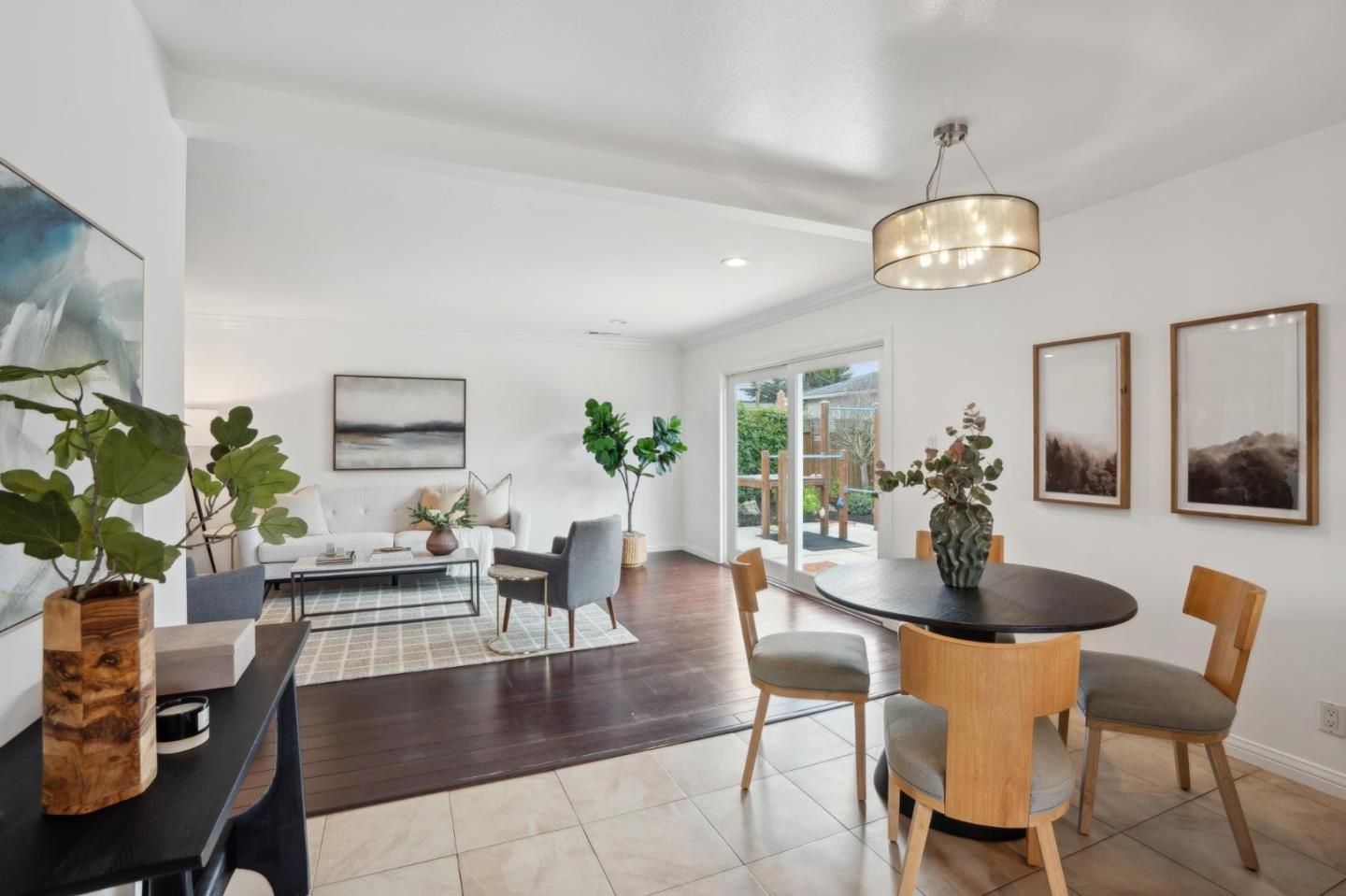 907 3rd Avenue Half Moon Bay, CA 94019 - Photo 18 of 37 a dining room with wooden floor a chandelier a glass table and chairs