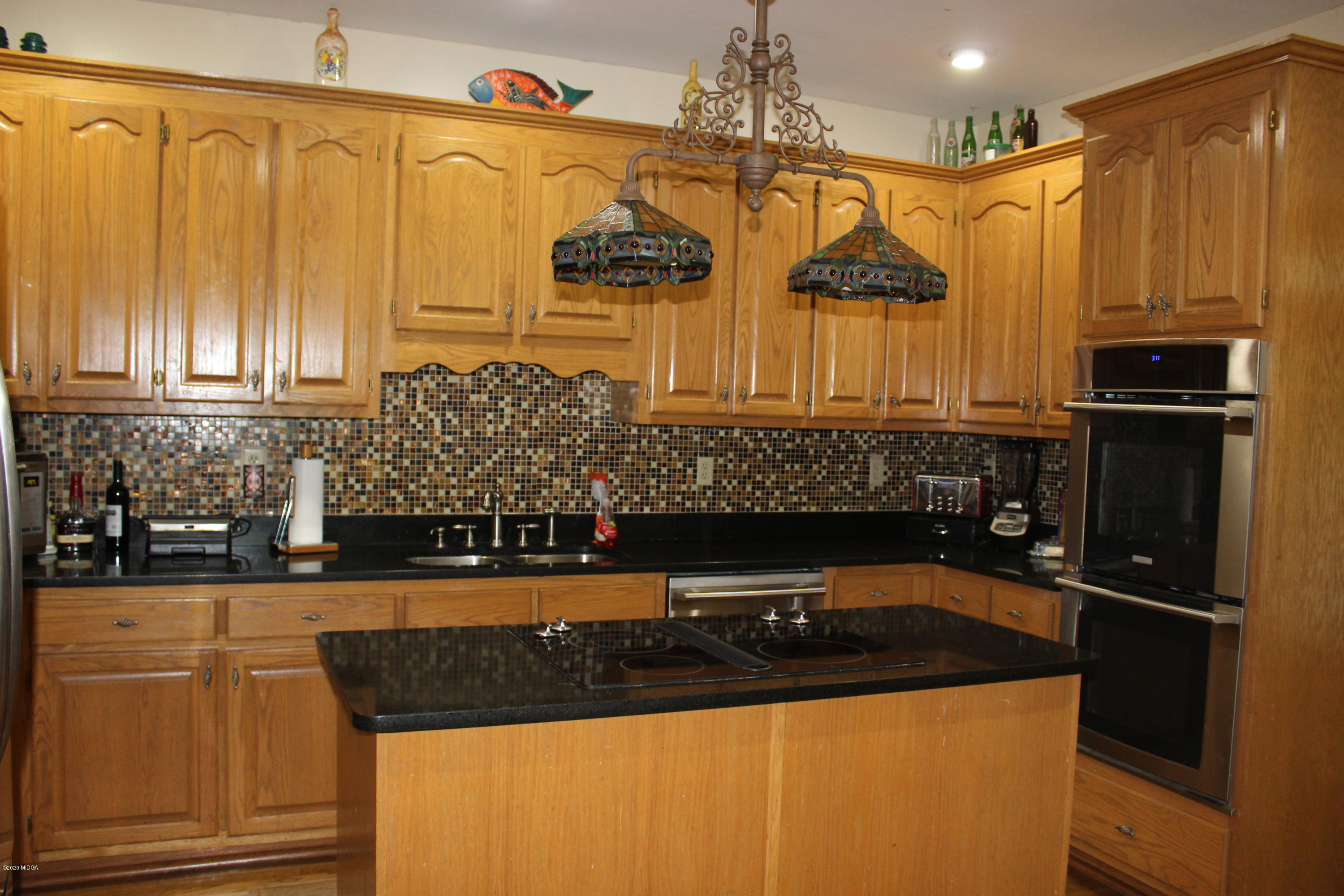 30 Chambless Road Forsyth, GA 31029 - Photo 11 of 27 a kitchen with stainless steel appliances granite countertop a sink a stove and a refrigerator