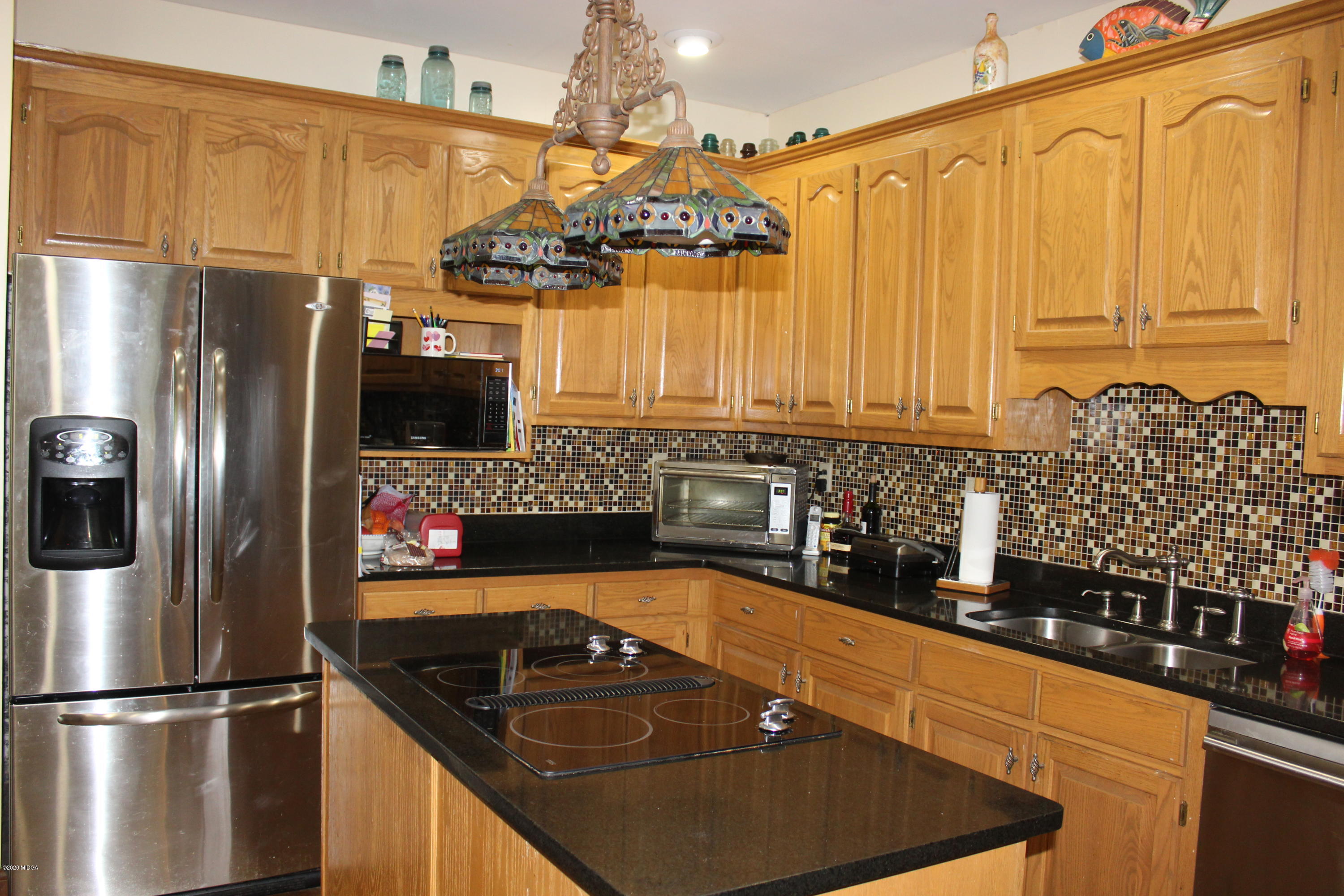 30 Chambless Road Forsyth, GA 31029 - Photo 12 of 27 a kitchen with stainless steel appliances granite countertop a sink a stove and refrigerator