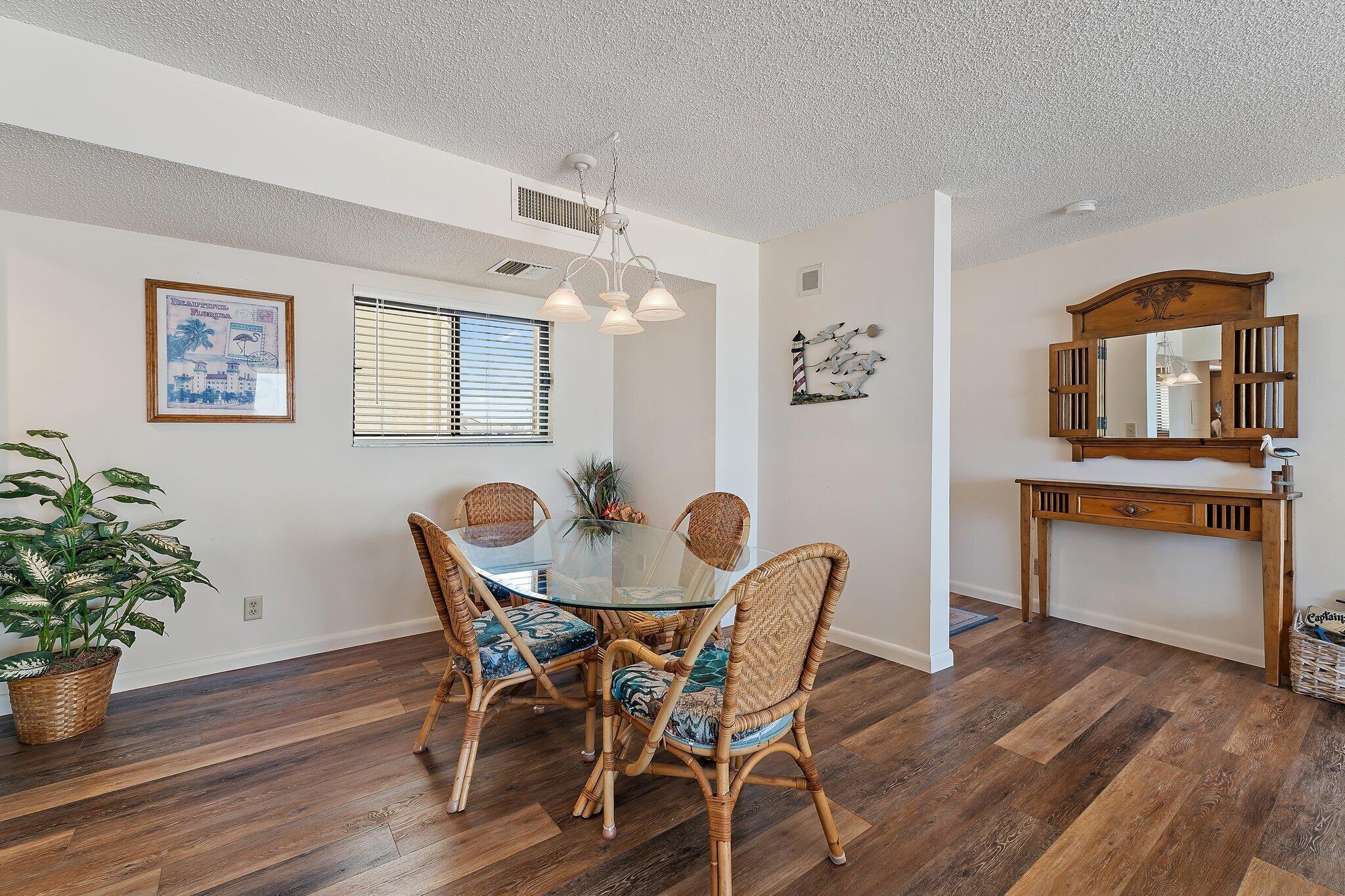 300 Ocean Trail Way, Unit 403 Jupiter, FL 33477 - Photo 15 of 50 a view of a dining room with furniture and wooden floor