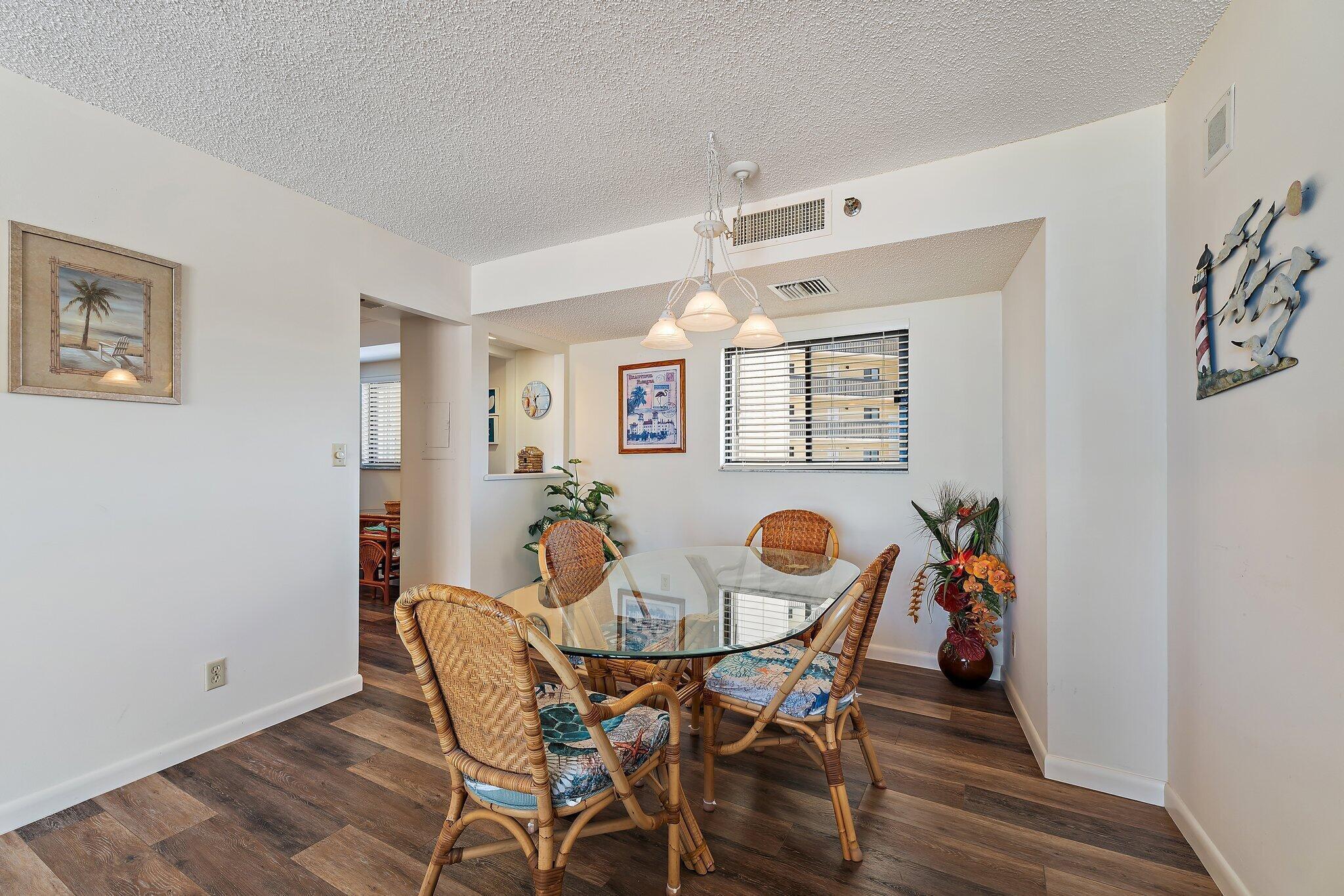 300 Ocean Trail Way, Unit 403 Jupiter, FL 33477 - Photo 16 of 50 a view of a dining room with furniture and wooden floor