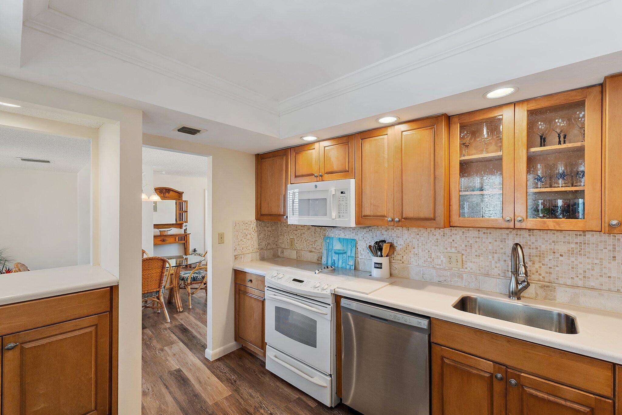 300 Ocean Trail Way, Unit 403 Jupiter, FL 33477 - Photo 20 of 50 a kitchen that has a sink and a stove in it