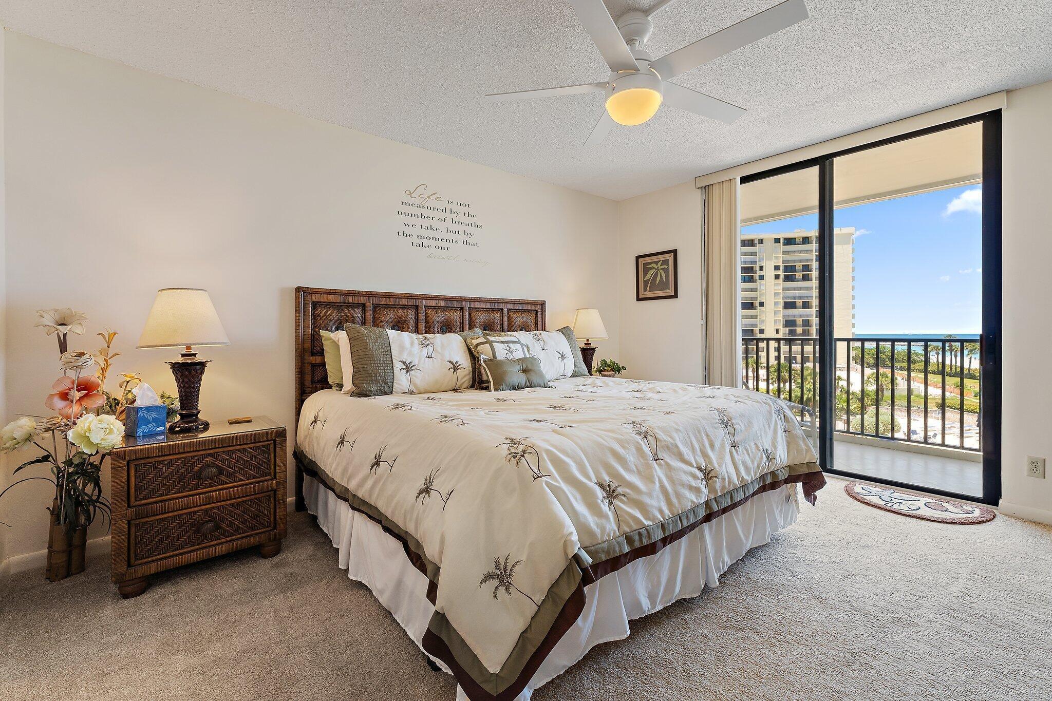 300 Ocean Trail Way, Unit 403 Jupiter, FL 33477 - Photo 21 of 50 a spacious bedroom with a bed and a large window