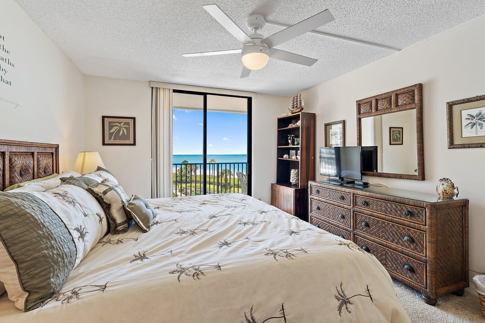 300 Ocean Trail Way, Unit 403 Jupiter, FL 33477 - Photo 22 of 50 a bedroom with a bed and a flat screen tv